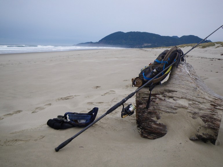 My gear on a log; tides way out with a lot of sandy beach exposed