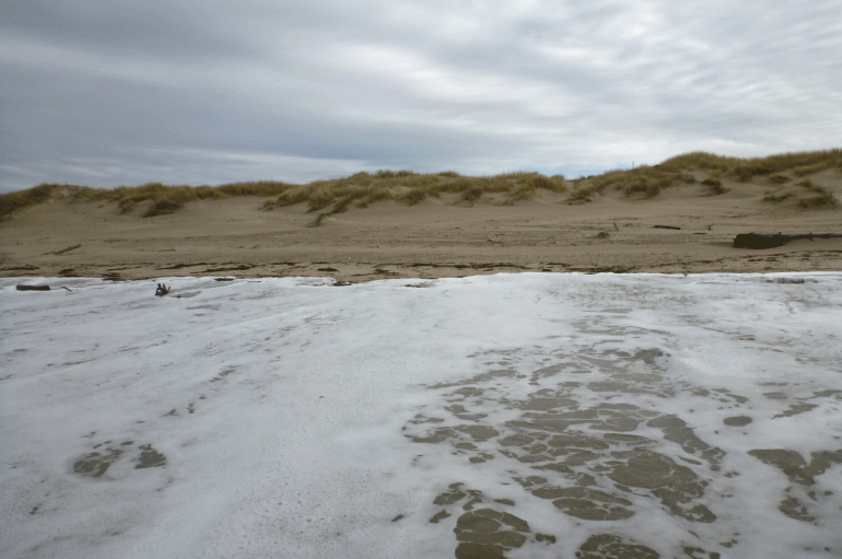The surge from a 10.0' high tide races up the beach
