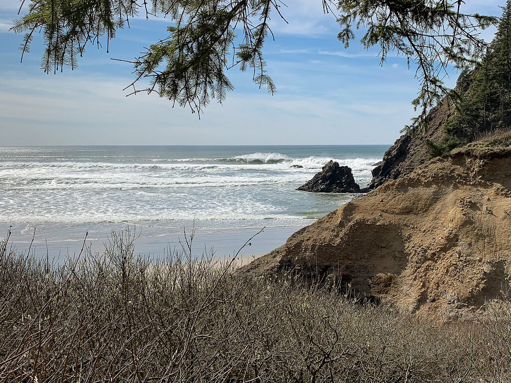 View out to sea, headland on the left, good-sized waves