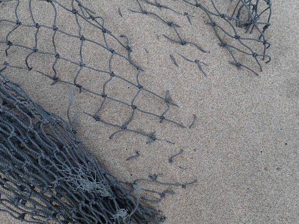 Lost fishing net in sand