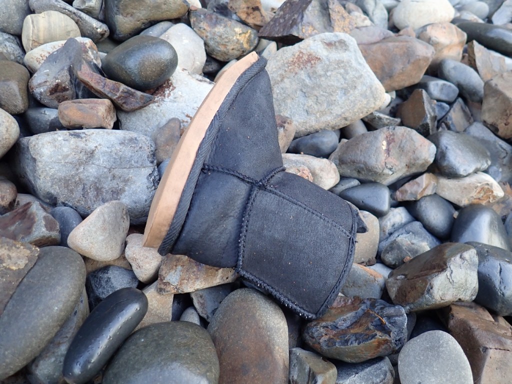A insulated soled bootie rests on the cobbles.