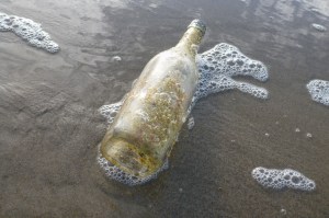 A drift glass bottle rolling around in the swash.