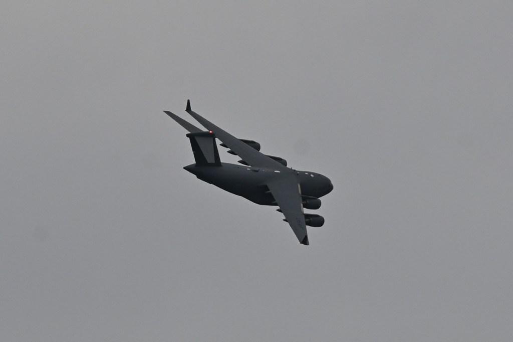 A Boeing C-17 Globemaster III practicing low and slow. Cloudy sky.