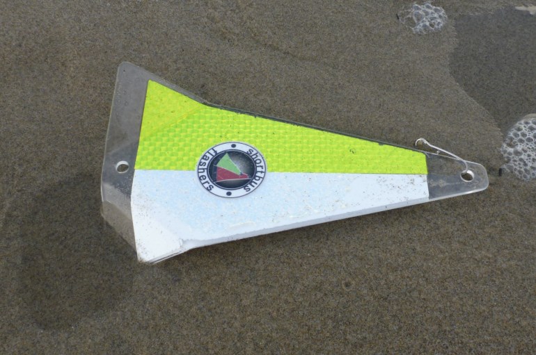 A lost shortbus flasher, generally used trolling for salmon, rests on the sand.